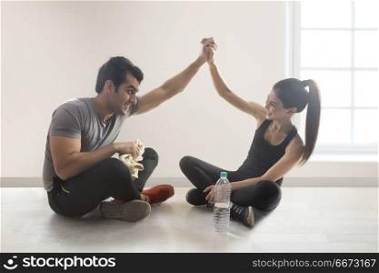 Young couple relaxing after workout and having fun