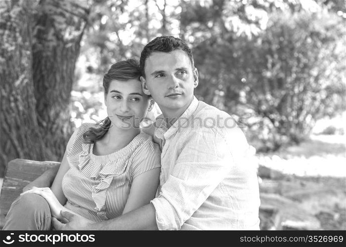 Young couple relaxing in park on a bench