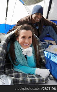 Young couple relaxing in tent.
