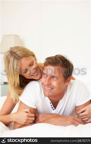Young Couple Relaxing On Bed