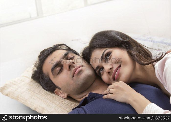 Young couple relaxing on bed