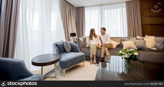 Young couple relaxing on couch in luxury living room