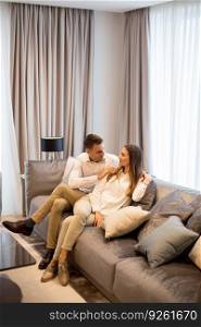 Young couple relaxing on couch in luxury living room