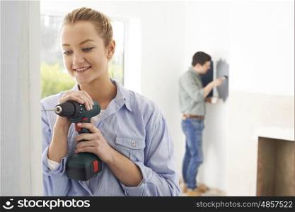 Young Couple Rennovating Property Together