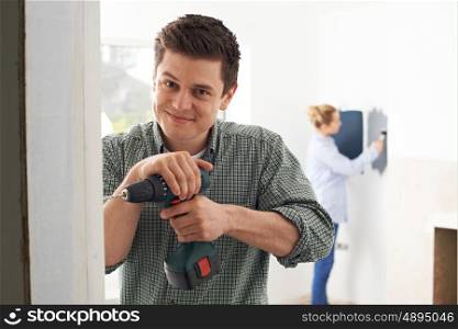 Young Couple Renovating Property Together