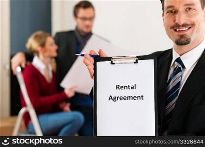 Young couple renting a home or apartment, they are meeting the owner or real estate broker standing in front