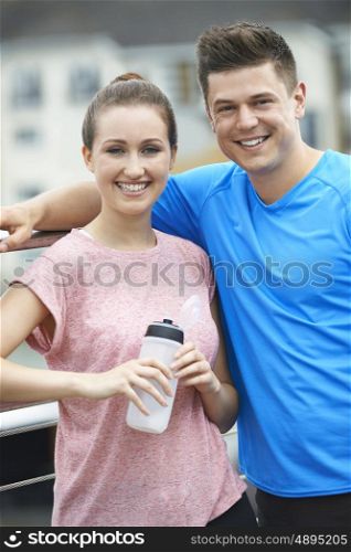 Young Couple Resting During Run In City