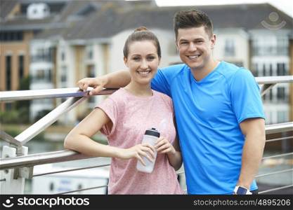 Young Couple Resting During Run In City