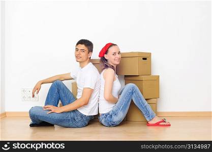 Young couple resting from moving into a new home. Great copy space.