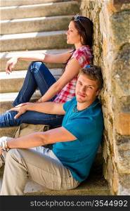 Young couple resting on stone stairs leisure time in city