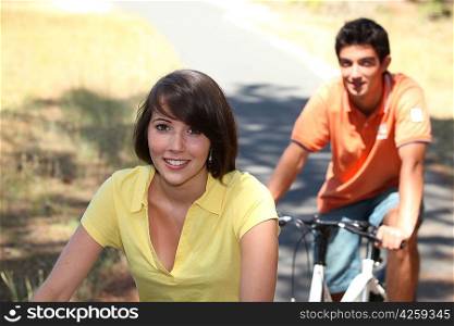 Young couple riding bikes