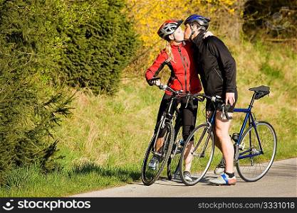 Young couple riding their bikes at a wonderful spring day