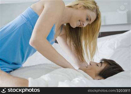Young couple romancing on the bed