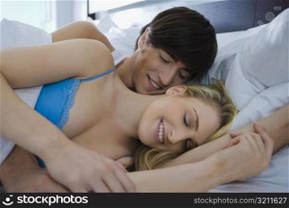 Young couple romancing on the bed