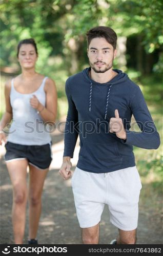 young couple running at the nature