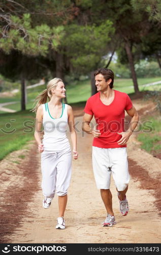 Young couple running in park