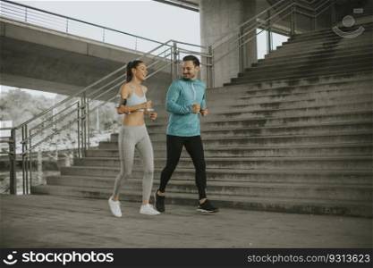 Young couple running in the urban enviroment