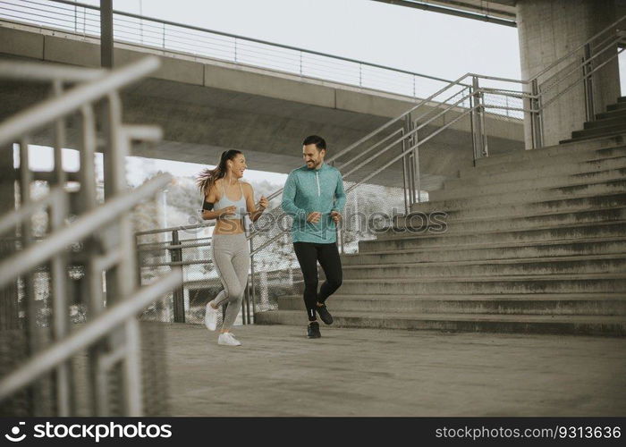 Young couple running in the urban enviroment