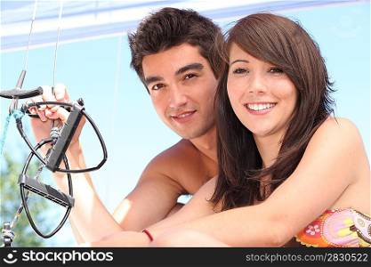 Young couple sailing a catamaran