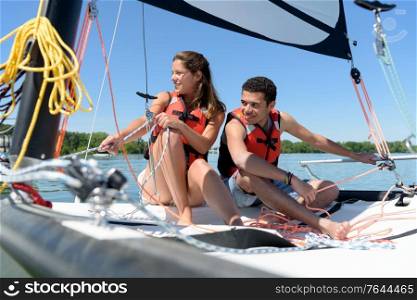 young couple sailing during summer holidays