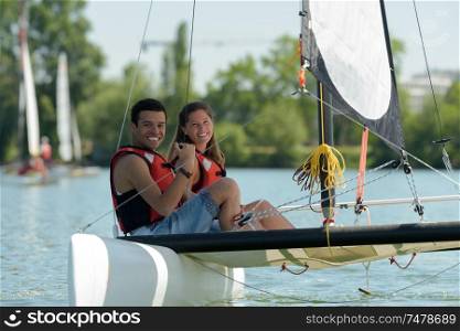 young couple sailing in a lake