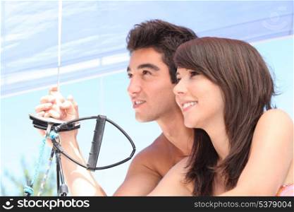 Young couple sailing in the summer