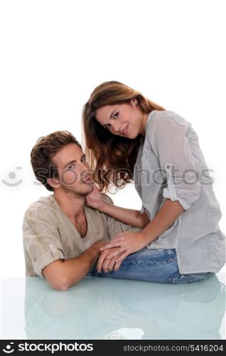 Young couple sat on glass desk