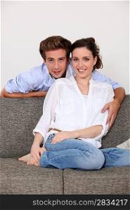 Young couple sat on sofa