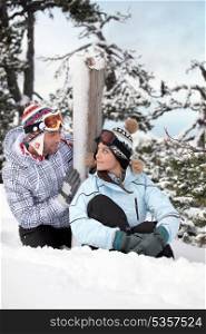 Young couple sat on the snow