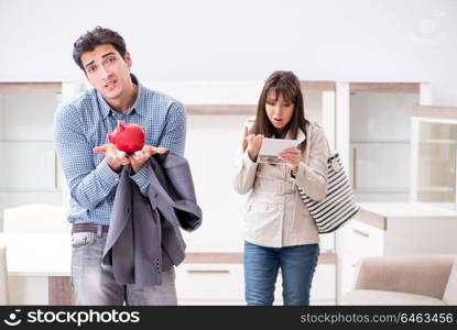 Young couple saving money for new furniture