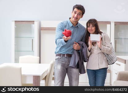 Young couple saving money for new furniture