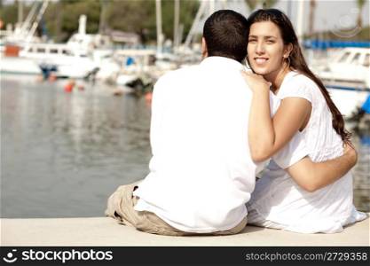 Young Couple Seated and Hugging On A Footbridge , Focus On Female