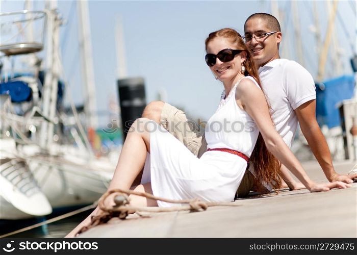 Young Couple Seated and Hugging On A Footbridge , Focus On Female