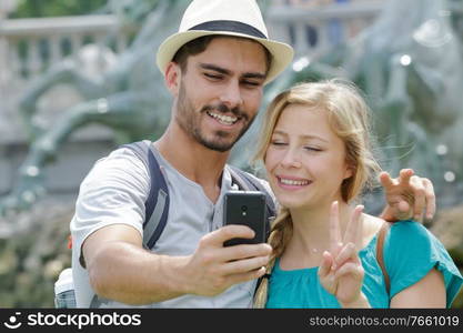 young couple selfy on street