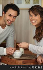 Young couple sharing a bowl of cornflakes