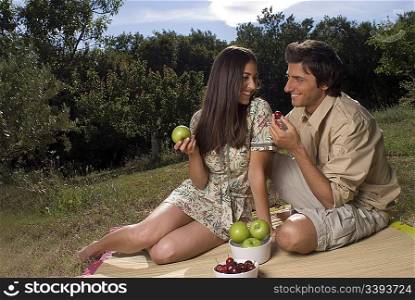 Young couple sharing fresh fruit
