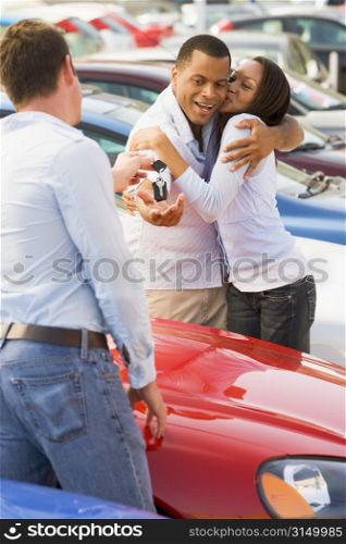 Young couple shopping for a new car
