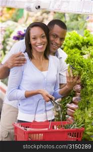 Young couple shopping for lettuce at a grocery store