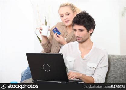 young couple shopping online with bank card