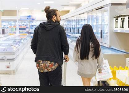 young couple shopping supermarket