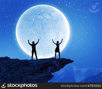 Young couple. Silhouettes of young couple at night under big moon