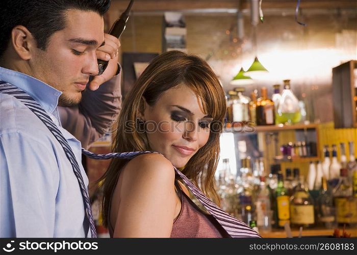 Young couple singing and dancing at local bar, night