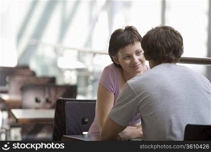 Young couple sit in food hall of shopping mall Voronezh