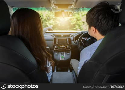 young couple sitting and driving in a car