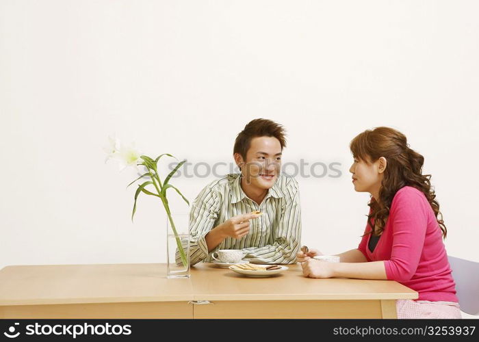 Young couple sitting and looking at each other