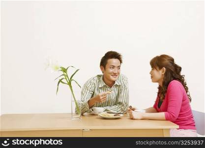 Young couple sitting and looking at each other