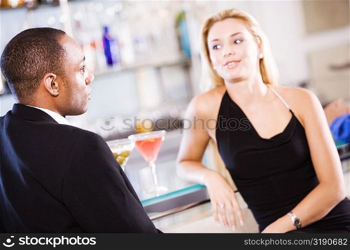 Young couple sitting at a bar counter