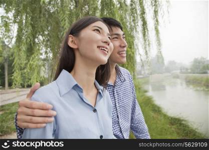 Young Couple Sitting by a Canal
