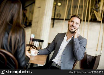 Young couple sitting in a cafe and talking