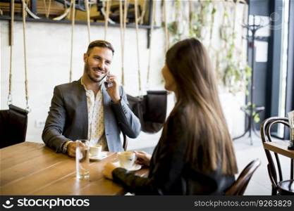 Young couple sitting in a cafe and talking
